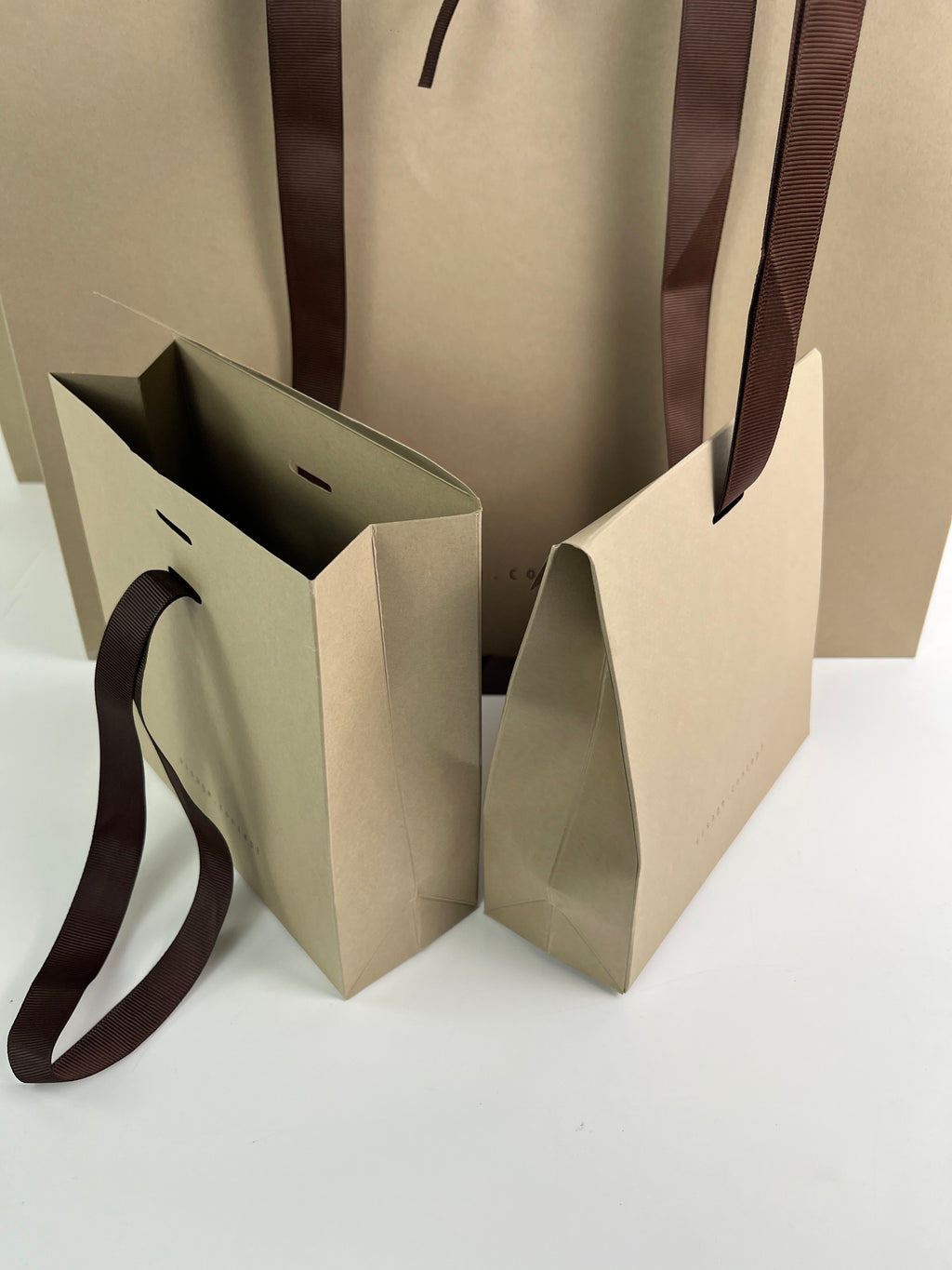 Custom 270gsm Taupe Specialty Paper Shopping Bags with Brown Grosgrain Ribbon Handles