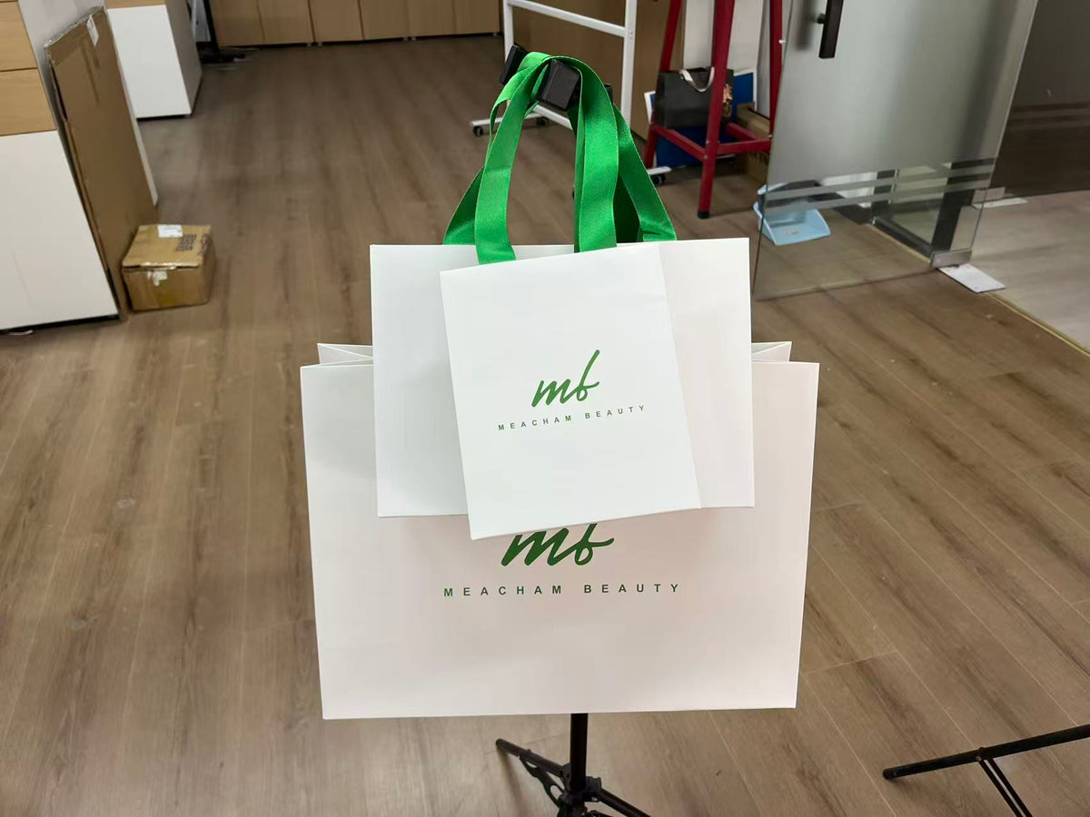 Custom White Paper Shopping Bags with Green Ribbon Handles | MOQ Available for Beauty & Retail Packaging