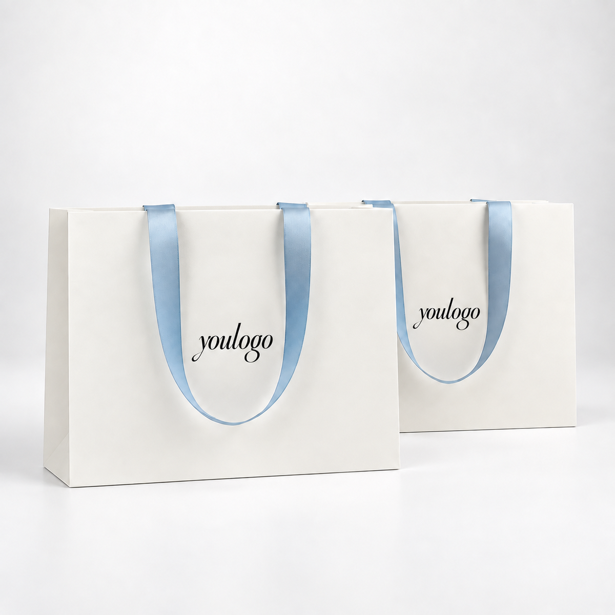 Custom 250gsm White Paper Shopping Bags with Concealed Blue Satin Ribbon Handles