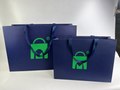 Custom Navy Blue Paper Shopping Bags | Ivory Interior & Satin Ribbon Handles | Luxury Retail Packaging