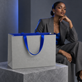 Custom Grey Specialty Paper Shopping Bags with Concealed Royal Blue Satin Ribbon Handles