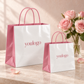 Custom White & Pink 350gsm Specialty Paper Shopping Bags with Pasted Twisted Handles